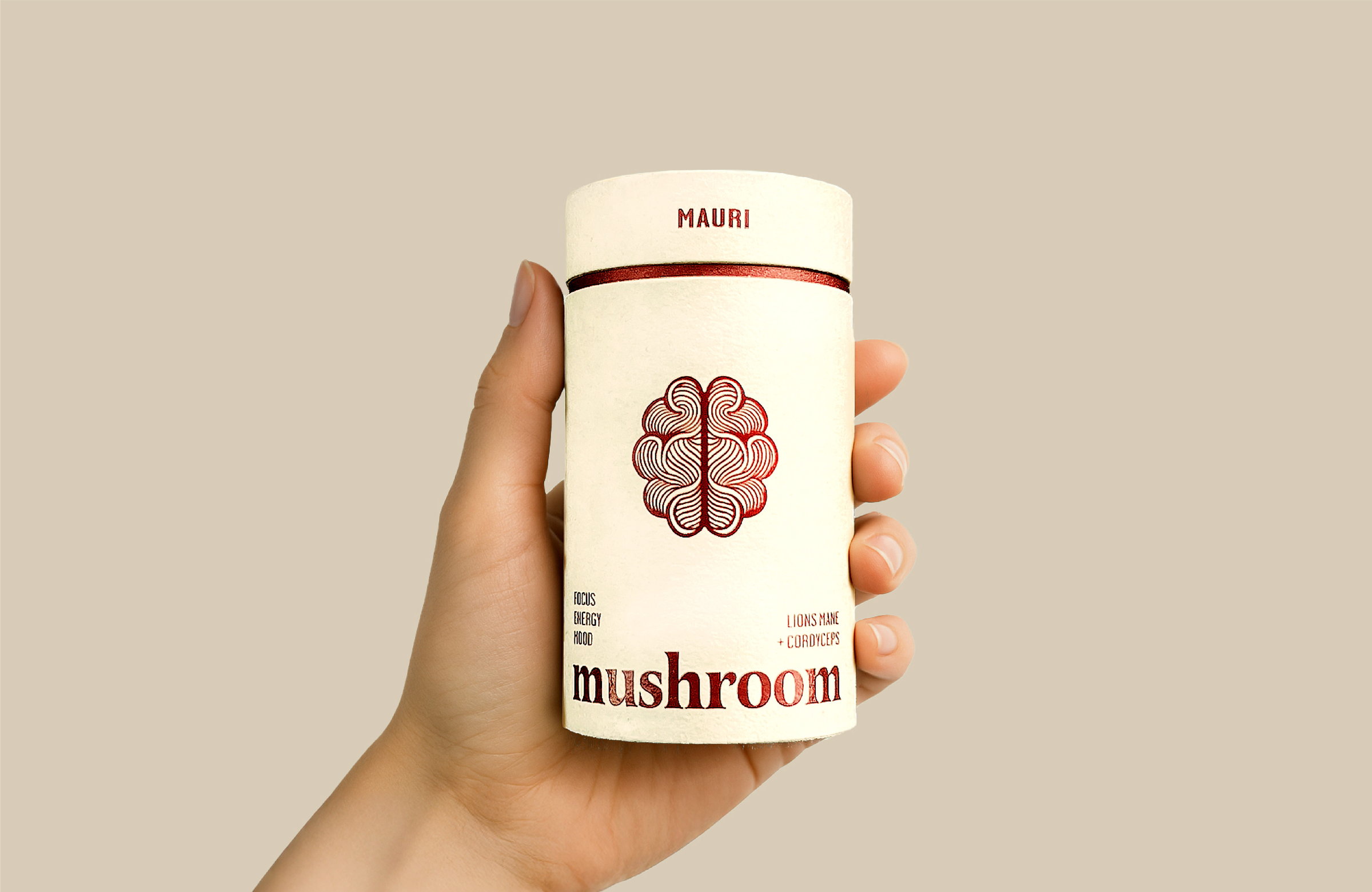 A hand holding a Mauri mushroom tube, label facing out